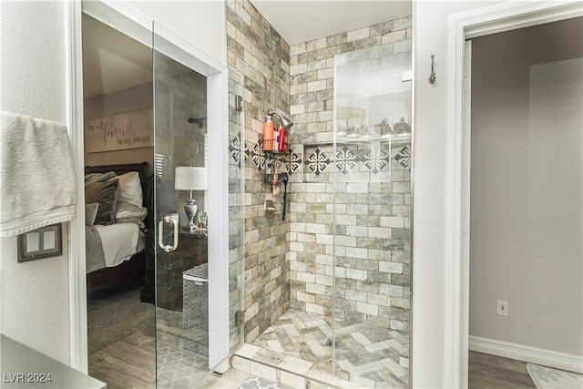 bathroom featuring a shower with door and hardwood / wood-style flooring