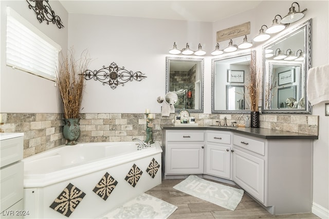 bathroom with vanity, hardwood / wood-style flooring, and a bathing tub