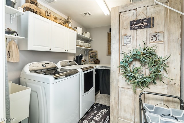 laundry area with sink, cabinets, and washer and clothes dryer