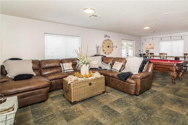 living area with visible vents, billiards, and stone finish floor