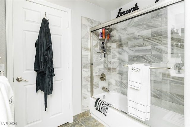 bathroom with bath / shower combo with glass door