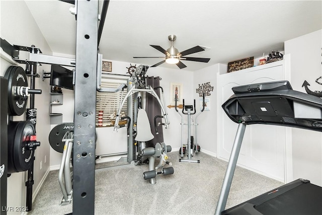 exercise area featuring ceiling fan and baseboards