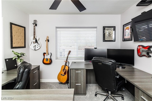 office space with carpet floors, a ceiling fan, and baseboards