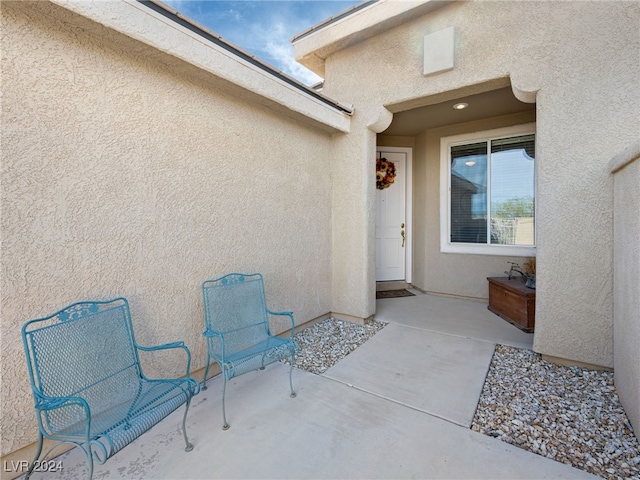 doorway to property with a patio area