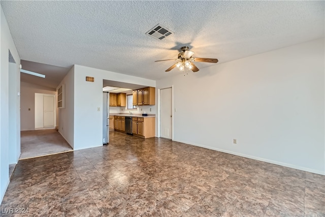 unfurnished living room featuring a textured ceiling, ceiling fan, and sink