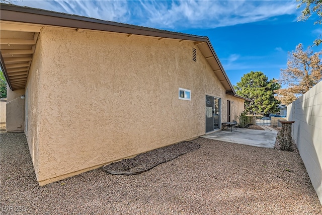 view of side of property with a patio