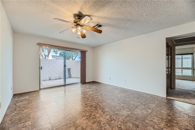 unfurnished room with a textured ceiling and ceiling fan