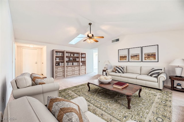 living room with carpet flooring, ceiling fan, and lofted ceiling with skylight