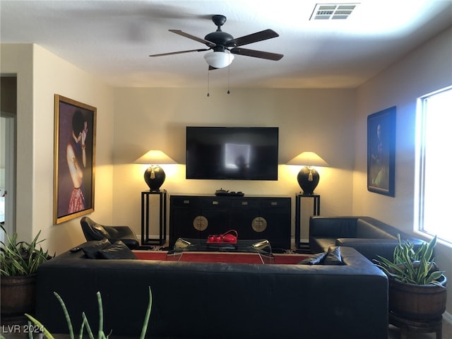 living room with ceiling fan and a wealth of natural light