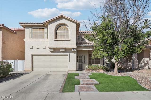 view of front of home with a garage and a front lawn