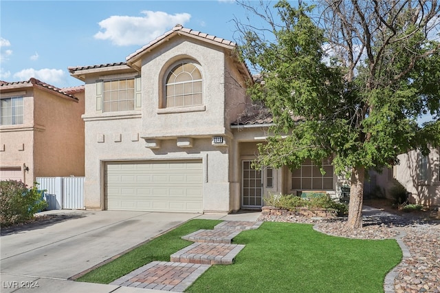 view of front of house featuring a front lawn and a garage