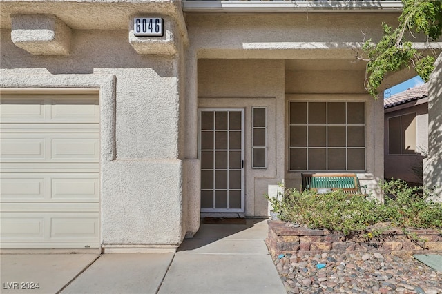 doorway to property featuring a garage