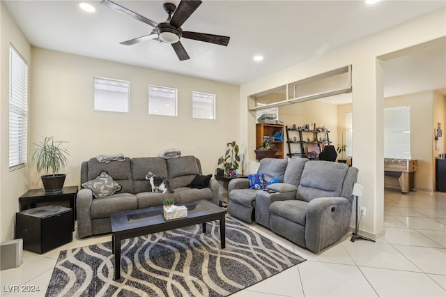 tiled living room featuring ceiling fan and a wealth of natural light