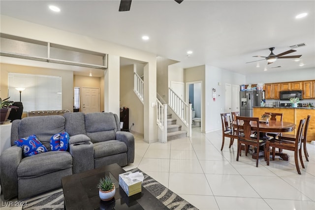 living room with light tile patterned flooring and ceiling fan