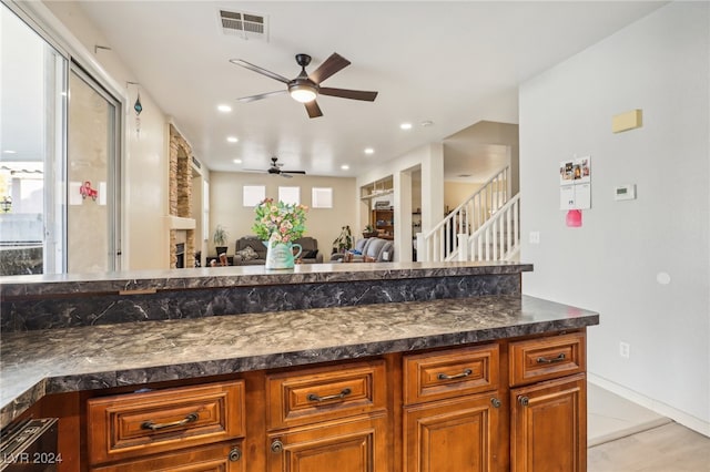 kitchen with dark stone countertops and ceiling fan