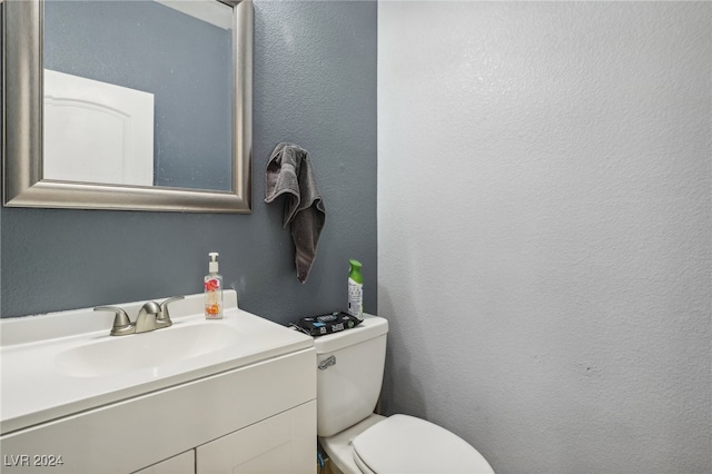 bathroom featuring toilet and vanity