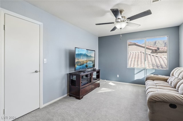 carpeted living room featuring ceiling fan