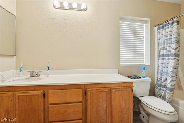 full bathroom with vanity, toilet, and shower / tub combo with curtain