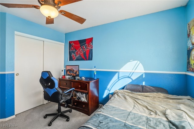 carpeted bedroom featuring a closet and ceiling fan