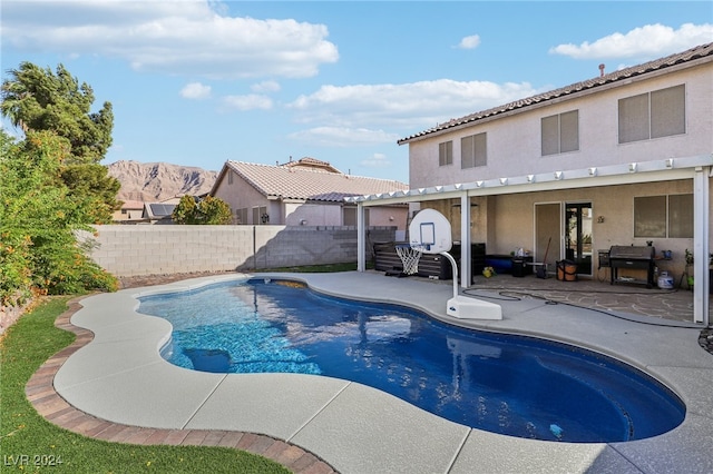 view of pool with a mountain view and a patio