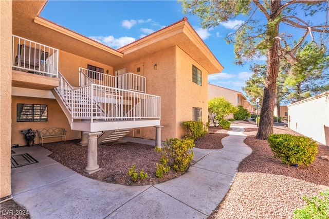 view of property exterior with a patio area