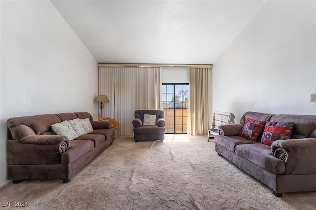 carpeted living room featuring vaulted ceiling