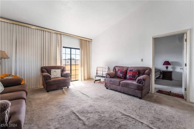 living room with light colored carpet and high vaulted ceiling