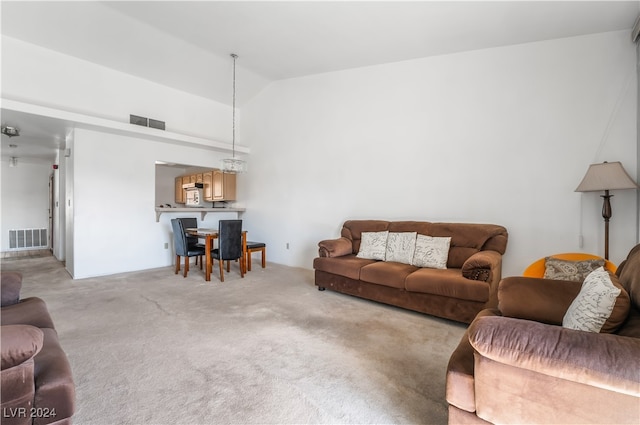 carpeted living room with lofted ceiling