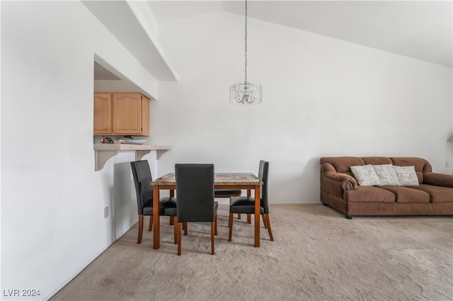 carpeted dining room with an inviting chandelier and vaulted ceiling