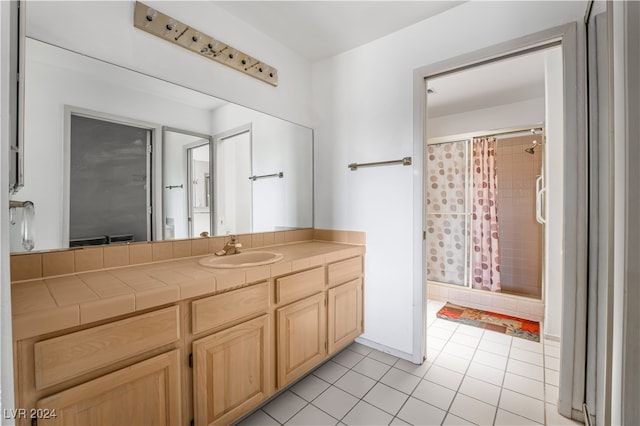 bathroom featuring vanity, walk in shower, and tile patterned flooring