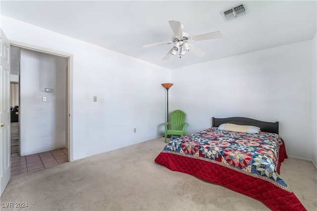 bedroom featuring light carpet and ceiling fan