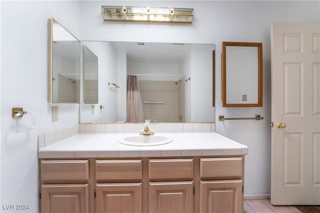 bathroom with vanity, tile patterned flooring, and a shower with shower curtain