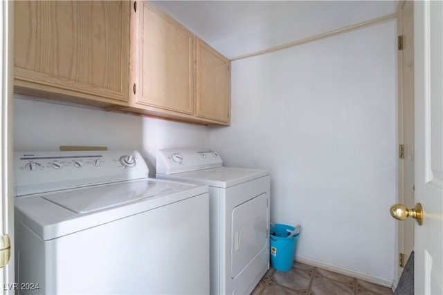 laundry area featuring separate washer and dryer and cabinets