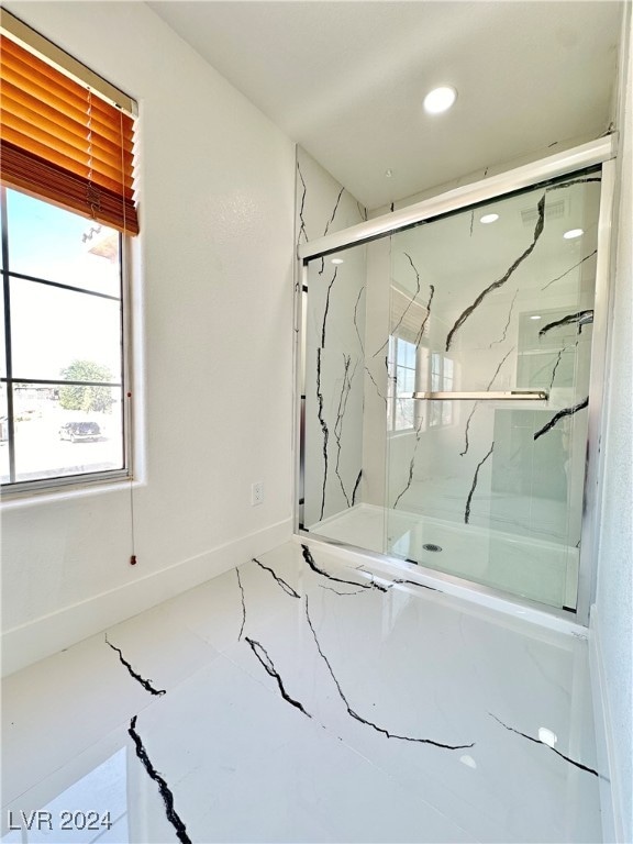 bathroom with a shower with shower door