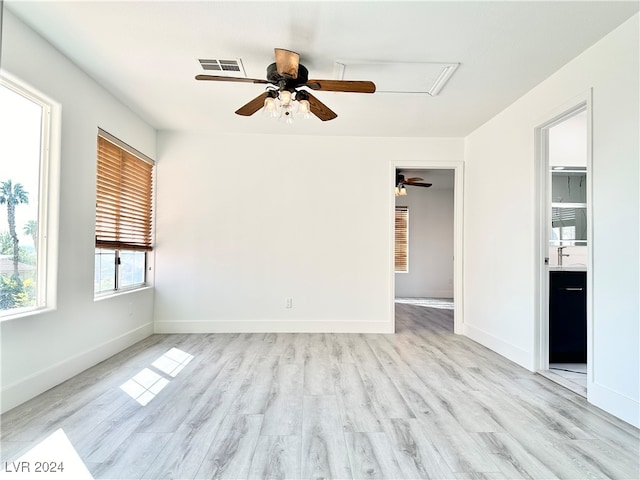 unfurnished room featuring light hardwood / wood-style flooring, sink, and ceiling fan