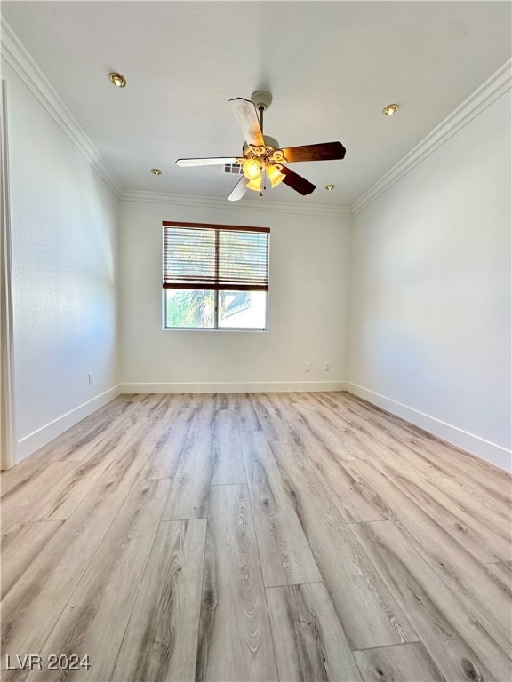 spare room featuring crown molding, light hardwood / wood-style flooring, and ceiling fan