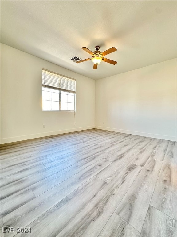 spare room with light hardwood / wood-style floors and ceiling fan