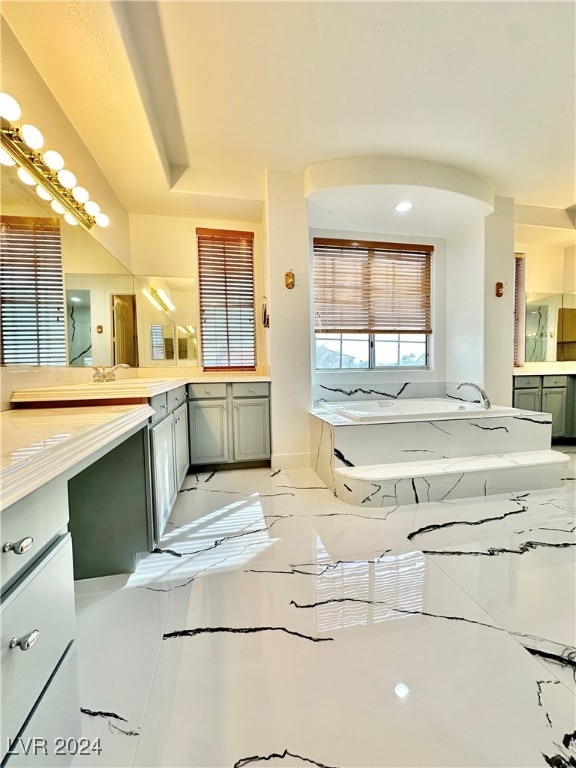 bathroom featuring vanity, a bathtub, and tile patterned flooring