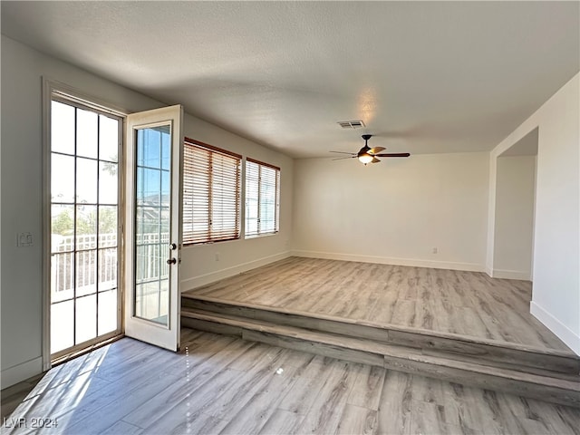 interior space featuring plenty of natural light, light wood-type flooring, and ceiling fan