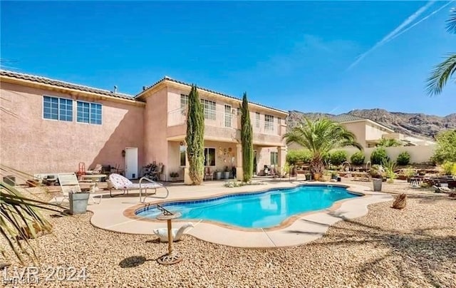 view of pool with a patio area and a mountain view