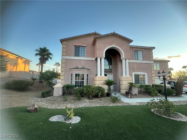 mediterranean / spanish-style house featuring a lawn