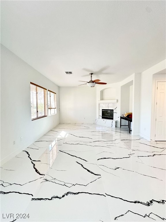 unfurnished living room with ceiling fan