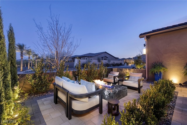 patio terrace at dusk featuring a fire pit