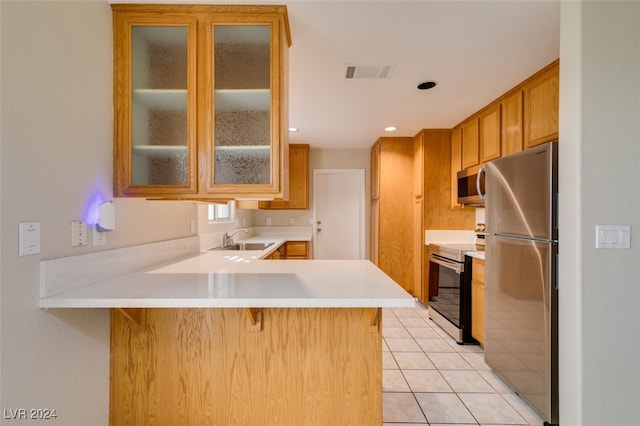 kitchen featuring sink, kitchen peninsula, a breakfast bar area, stainless steel appliances, and light tile patterned floors