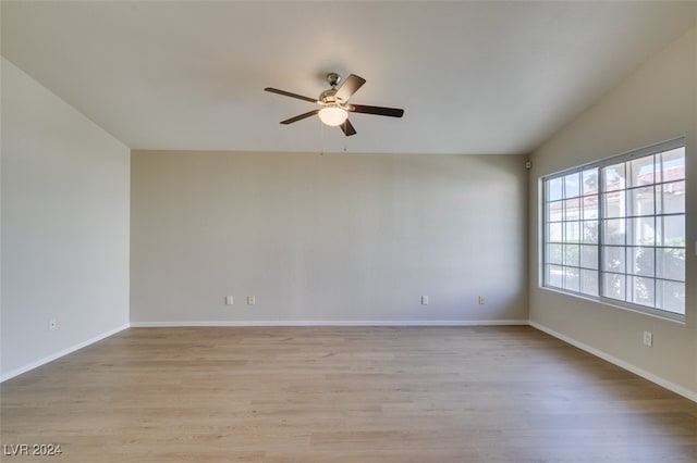 unfurnished room with ceiling fan, lofted ceiling, and light hardwood / wood-style flooring