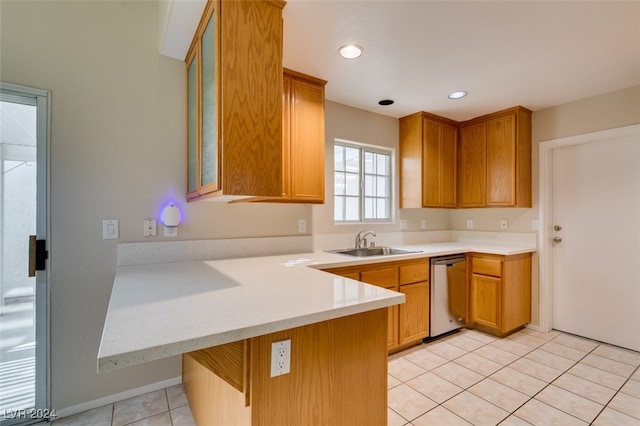 kitchen featuring kitchen peninsula, light tile patterned floors, a breakfast bar area, dishwasher, and sink