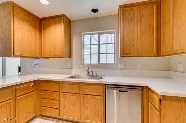 kitchen with light tile patterned floors, sink, and stainless steel dishwasher