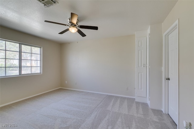 empty room with light carpet and ceiling fan