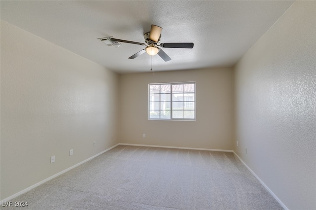 empty room featuring light carpet and ceiling fan