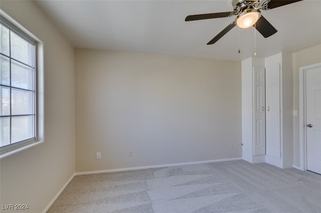 carpeted empty room with ceiling fan